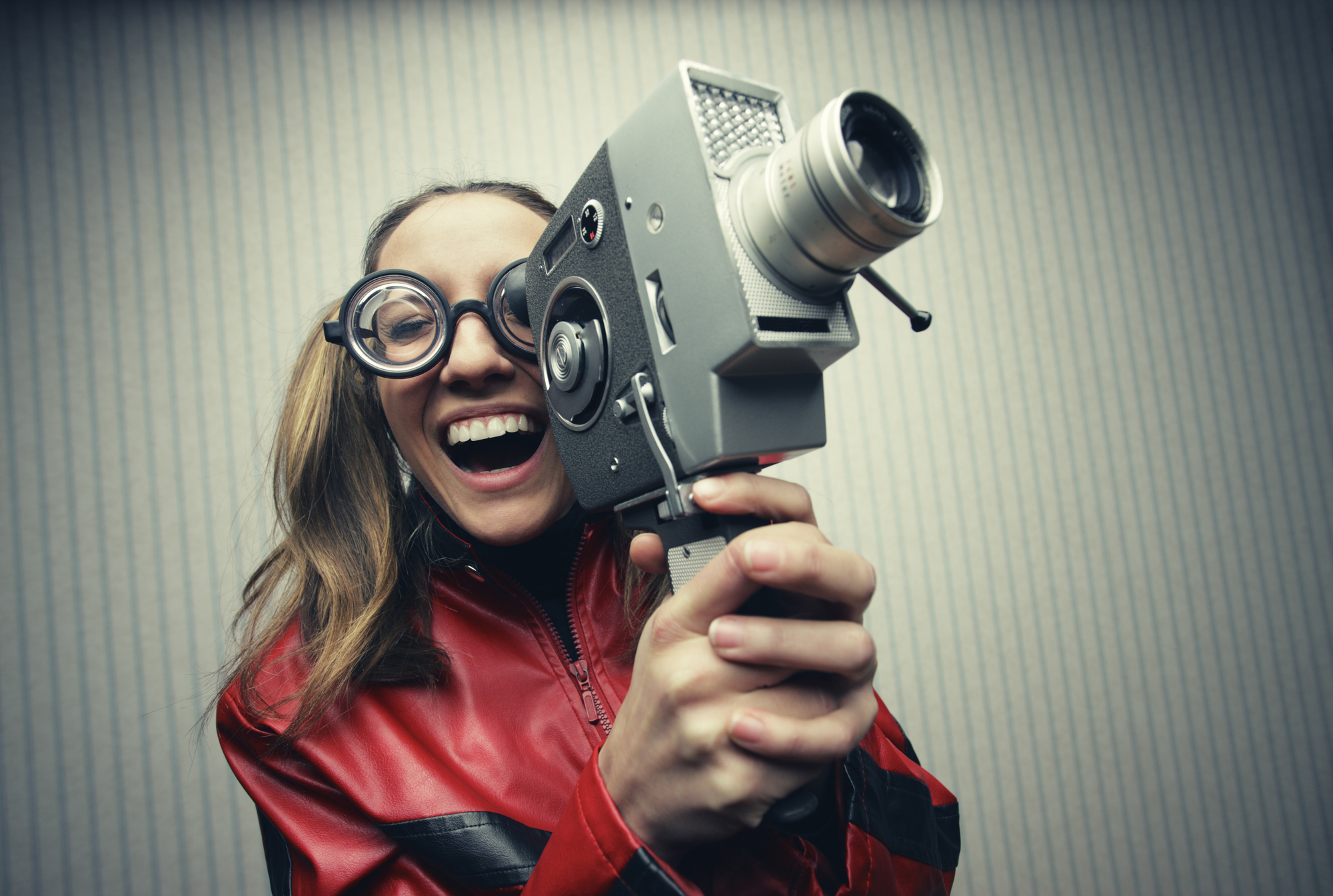 Nerdy woman with old fashion video camera