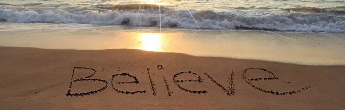 believe written in sand along beach shore