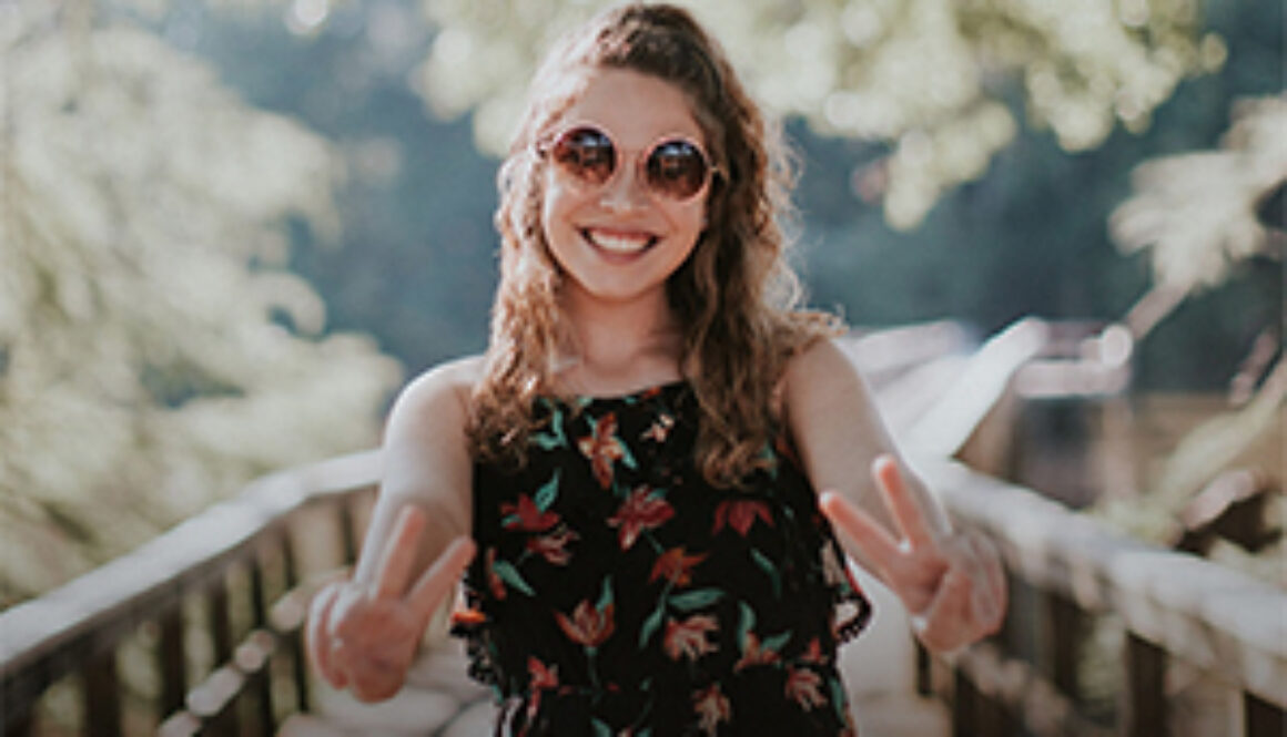 young successful woman pointing V for Victory fingers