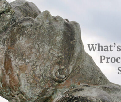 bronze statue close up man holding hand over head looking back
